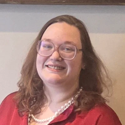 Dianna smiling in a red shirt.